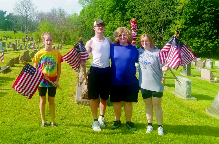 Flag placing to prepare cemetery for Memorial Day